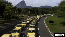 Taxis parked on the street are pictured during a protest against the online car-sharing service Uber in Rio de Janeiro, July 24, 2015.