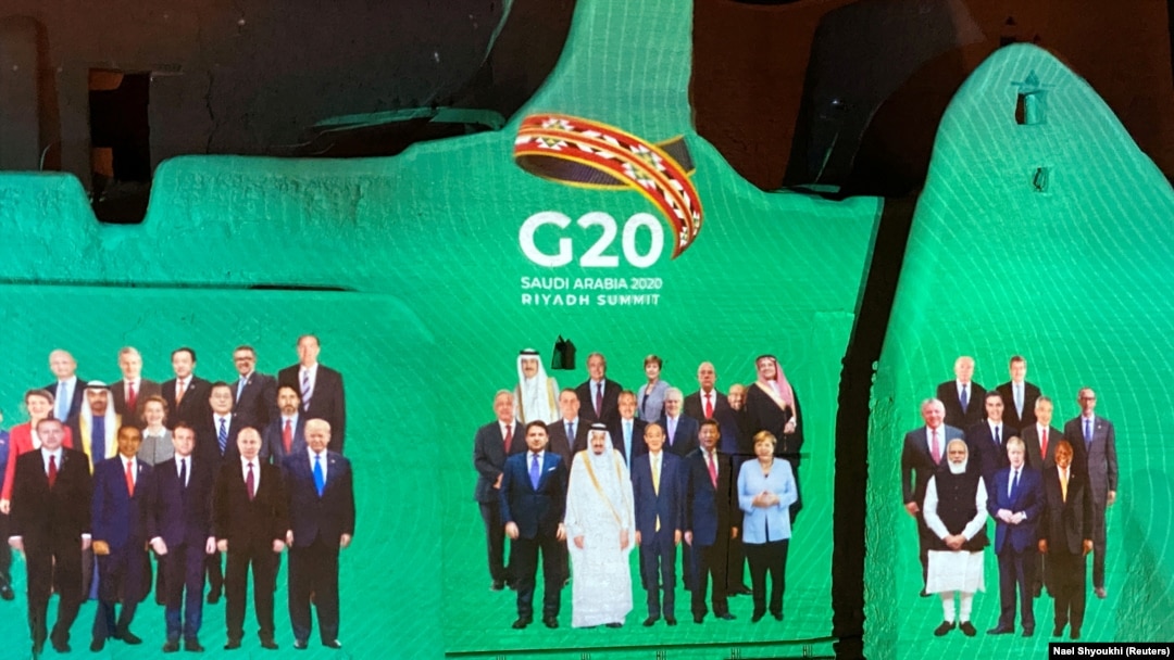 Saudi Arabia -- "Family Photo" for annual G20 Summit World Leaders is projected onto Salwa Palace in At-Turaif, one of Saudi Arabia's UNESCO World Heritage sites, in Diriyah, Saudi Arabia, November 20, 2020. REUTERS/Nael Shyoukhi