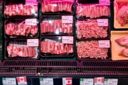 FILE - Packs of Canadian pork are displayed for sale at a supermarket in Beijing, June 18, 2019.