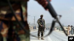 Afghan National Army soldiers stand guard at a checkpoint on the Jalalabad-Kabul road, on the outskirts of Kabul, April 28, 2019.