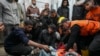 Palestinians mourn over the bodies of civil defense workers, victims of an Israeli army strike in the Nuseirat camp, at the Al-Aqsa Martyrs hospital in Deir al-Balah, central Gaza Strip, Dec.16, 2024.