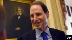 FILE - Sen. Ron Wyden, D-Ore. talks with a reporter before the start of a meeting with Senate Democrats on Capitol Hill in Washington, May 22, 2015. 