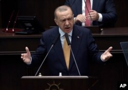 Turkey's President Recep Tayyip Erdogan addresses his ruling party lawmakers at the parliament, in Ankara, Turkey, Oct. 28, 2020.