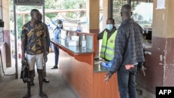 A port health officer screens travelers at a border post between Kenya and Uganda in Malaba, Kenya, on Aug. 20, 2024. Several African nations are screening for mpox amid an outbreak spreading around the continent.