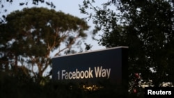 FILE - A Facebook address sign is seen at Facebook headquarters in Menlo Park, California.
