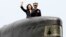 Taiwan's President Tsai Ing-wen, left, waves from a Zwaardvis-class submarine during a visit at Zuoying Naval base in Kaohsiung, southern Taiwan, Tuesday, March 21, 2017.
