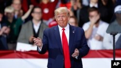 FILE - President Donald Trump arrives at a campaign rally in Battle Creek, Mich., Dec. 18, 2019. 