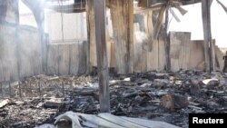 Debris from damaged buildings after gunmen stormed the headquarters of Al-Ikhbariya news channel near Damascus, June 27, 2012, in this handout photograph released by Syria's national news agency SANA.