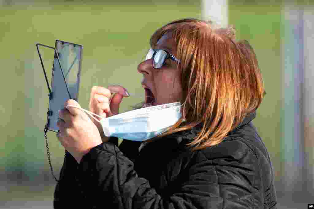 A member of the public swabs herself on the first day of the pilot scheme of mass testing in Liverpool. Liverpool is the pilot project for possible weekly testing of the entire population, covering up to 10 million people across England a day.