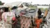 A Cambodia man, left, gets out from his home with floodwaters surrounding it in a slum in Phnom Penh, Cambodia, Tuesday, Oct. 4, 2011. Flash floods, the worst to hit Cambodia since 2000, have killed at least 150 people in this Southeast Asian nation since