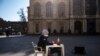 A pupil sits at a desk on Piazza Castello during a protest against the closure of schools from the seventh grade up, following new government restrictions over the COVID-19 pandemic, in Turin, Italy.