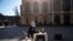 A pupil sits at a desk on Piazza Castello during a protest against the closure of schools from the seventh grade up, following new government restrictions over the COVID-19 pandemic, in Turin, Italy.