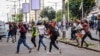 FILE - Protesters disperse as police deploy in Maputo, Mozambique, Nov. 7, 2024. Protesters dispute the outcome of Oct. 9 elections, which saw the ruling Frelimo party extend its 49-year rule.