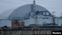 FILE PHOTO: A general view shows the New Safe Confinement structure over the old sarcophagus covering the damaged fourth reactor at the Chernobyl Nuclear Power Plant, in Chernobyl