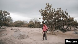 Renato Cortez looks for his family at an area affected by the eruption of the Fuego volcano at San Miguel Los Lotes in Escuintla, Guatemala, June 6, 2018.