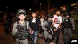 This picture taken on May 6, 2021, shows Israeli security forces detaining Palestinian protesters who were demonstrating in solidarity with local Palestinian families of the Sheikh Jarrah neighborhood of Israeli-annexed east Jerusalem.