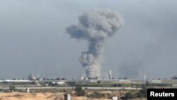 FILE - Smoke rises following Israeli strikes, amid the ongoing conflict between Israel and the Palestinian Islamist group Hamas, as seen from Rafah, in the southern Gaza Strip, January 8, 2024.