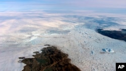 This 2016 photo provided by NASA shows patches of bare land at the Jakobshavn glacier in Greenland. The major Greenland glacier that was one of the fastest shrinking ice and snow masses on Earth is growing again, a new NASA study finds. (NASA via AP)