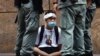 CHINA -- HONG KONG -- Riot police guard a protester as a second reading of a controversial national anthem law takes place in Central district, Hong Kong, Wednesday, May 27, 2020.