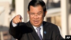 Cambodia's Prime Minister Hun Sen gestures as he arrives for a group photo of leaders at the 11th Asia-Europe Meeting (ASEM) in Ulaanbaatar, Mongolia, Saturday, July 16, 2016. (AP Photo/Mark Schiefelbein)