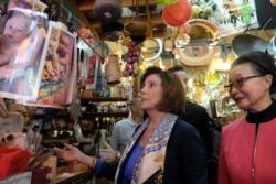 FILE - Speaker of the House Nancy Pelosi, D-Calif., looks over items at The Wok Shop during a tour of Chinatown, Feb. 24, 2020, in San Francisco.