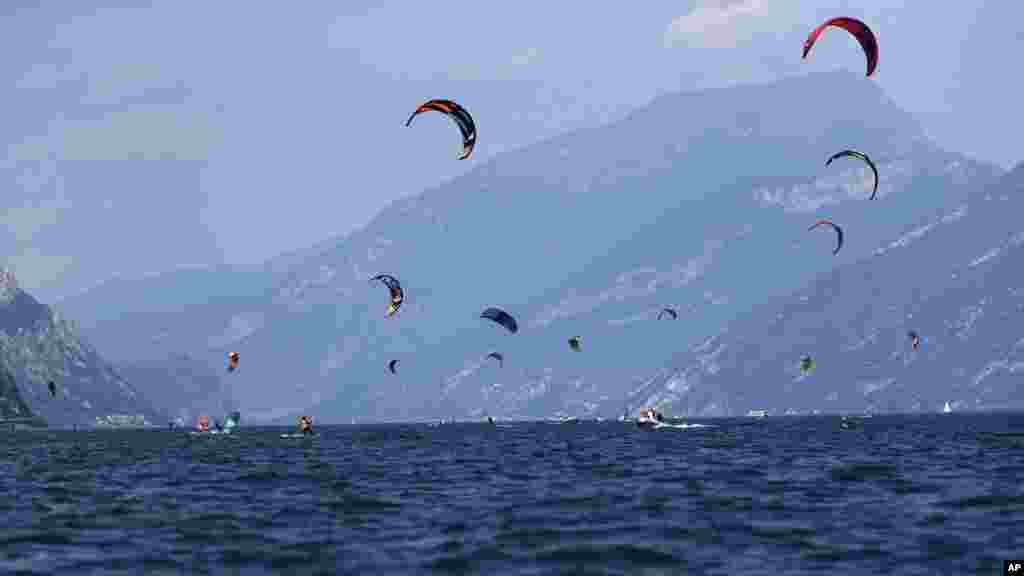 Kitesurfers enjoy the wind at the Garda lake near Brenzone, northern Italy, Aug. 5, 2019.