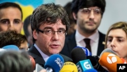 Ousted Catalan leader Carles Puigdemont addresses the media after a meeting with the president of the Parliament of Catalonia Roger Torrent in Brussels on Wednesday, Jan. 24, 2018. (AP Photo/Geert Vanden Wijngaert)