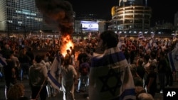 Israelis light a bonfire during a protest after Prime Minister Benjamin Netanyahu dismissed popular defense minister Yoav Gallant, in Tel Aviv, Israel, Nov. 5, 2024.