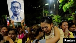 Well-wishers hug as they weep outside Thailand's King Bhumibol Adulyadej at the Siriraj hospital where he was residing in Bangkok, Thailand.