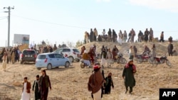 FILE - Afghan men leave after watching the public execution of a man by the Taliban at a football stadium in Gardez, in Paktia province, on Nov. 13, 2024. Taliban authorities defend their practice of public executions and public floggings, despite global outcry. 