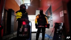 Police officers stand at the Seoul Western District Court after supporters of impeached South Korean President Yoon Suk Yeol broke into the court in Seoul, South Korea, Jan. 19, 2025.