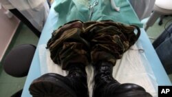A soldier in Harare waits for a surgical circumcision at a local clinic at the start of a campaign to lower the prevelance of AIDS in sub-Sharan Africa on Thursday, Oct. 28, 2010 .
