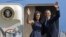 President Barack Obama and first lady Michelle Obama wave as they board Air Force One before leaving Charlotte, N.C., after the Democratic National Convention, Sept. 7, 2012. 