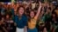 Soccer fans celebrate the second goal scored by Brazil striker Neymar, during a live broadcast at a World Cup viewing party at the Jockey Club, in Rio de Janeiro, Brazil, Thursday, June 12, 2014.