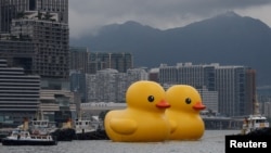 FILE - An art installation dubbed "Double Ducks" by Dutch artist Florentijn Hofman, is seen at Victoria Harbour, in Hong Kong, China June 9, 2023. (REUTERS/Tyrone Siu)