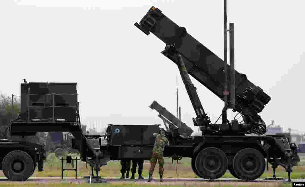Dutch soldiers are seen standing next to a Patriot missile battery at a military base in Adana, southern Turkey, January 26, 2013.