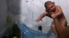 Daniele Santos, 29, holds her son Juan Pedro who is 2-months-old and born with microcephaly, after bathing him at their house in Recife, Brazil, Feb. 9, 2016. 