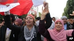 Tunisians are seen celebrating on Habib Bourguiba Boulevard in Tunis marking the one year anniversary of their revolution, Saturday, January 14, 2012.