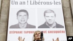 A gathering in support of Herve Ghesquiere and Stephane Taponier, two journalists from France 3 television who are held hostage by the Taliban in Afghanistan, in front Paris city hall, 29 Dec 2010