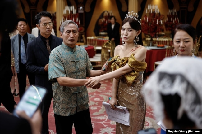 Actor Zhu Jian, 69, rehearses with other actors on the set of a micro drama (or movie) in Zhengzhou, China July 16, 2024. (Reuters/Tingshu Wang)