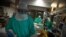 FILE -  Healthcare workers attend to COVID-19 coronavirus patients at the Intensive Unit Care of the Povisa Hospital in Vigo, northwestern Spain, on April 16, 2020. 
