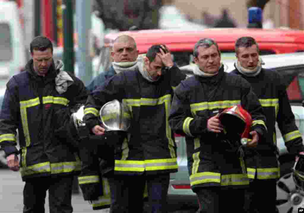 French firefighters leave after a police assault on a suspected Islamic extremist holed up in an apartment in Toulouse, southwestern France, Thursday, March 22, 2012. Mohamed Merah, who boasted of killing seven people to strike back at France died Thursda