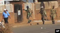 FILE - Soldiers patrol the streets in Harare, Zimbabwe, following demonstrations by opposition party supporters, Aug. 1, 2018. 