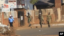 FILE - Soldiers patrol the streets in Harare, Zimbabwe, following demonstrations by opposition party supporters, Aug. 1, 2018. 