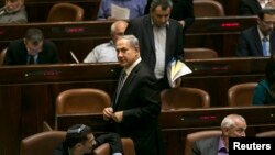 Israel's Prime Minister Benjamin Netanyahu leaves after a vote to dissolve the Israeli parliament, also known as the Knesset, in Jerusalem, Dec. 8, 2014. 