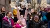 Children and their parents release birds celebrating the Annunciation on the eve of Orthodox Easter in front of the St. Tatiana Church in Moscow, Russia.