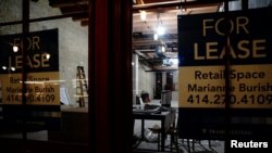 "For lease" signs are seen on an empty retail space s the COVID-19 outbreak continues in the Historic Third Ward neighborhood of Milwaukee, Wisconsin, Oct. 31, 2020.