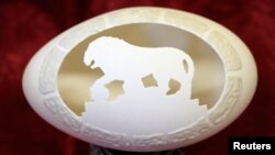 An egg which has been cut into designs by an artist Ludmila Kletz is on display during an exhibition in St. Petersburg, April 24, 2014. More than 30 works of chicken, goose and ostrich eggs were presented on Thursday. The artist uses miniature drills to c