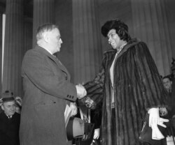 FILE - American contralto, Miss Marian Anderson, right, is shown with Secretary of Interior Harold Ickes before a concert on the steps of Lincoln Memorial in Washington, D.C. on Easter Sunday, April 9, 1939.