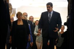 FILE - U.N. High Commissioner for Human Rights Michelle Bachelet, left, chats with Venezuela's President Nicolas Maduro, as they walk out of a meeting at Miraflores Presidential Palace, in Caracas, Venezuela, June 21, 2019.